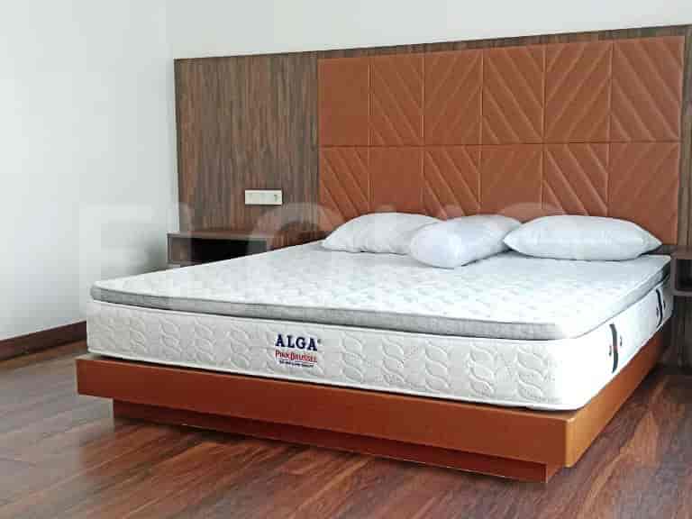 Bedroom with a bed, bedside tables, and headboard.