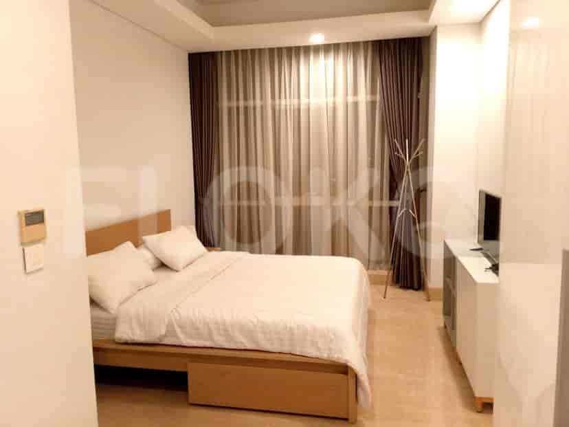 A modern bedroom with a bed, curtains and window.