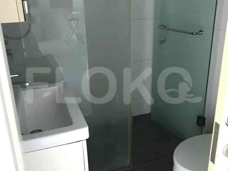 Modern bathroom featuring a sink and a shower with a glass door.