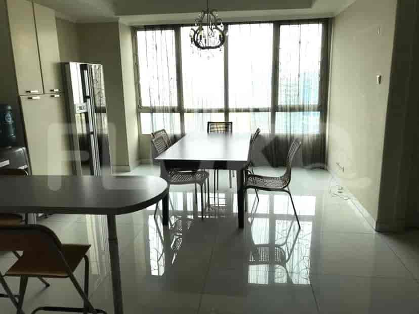 Spacious dining area with a large table, chandelier, and a water cooler.