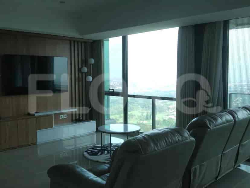A modern living room with large windows and a view.