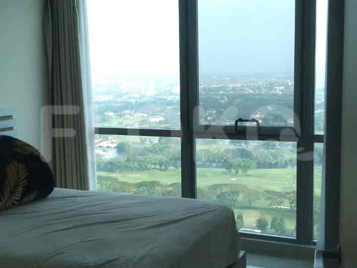 Bedroom with a large window and a view.