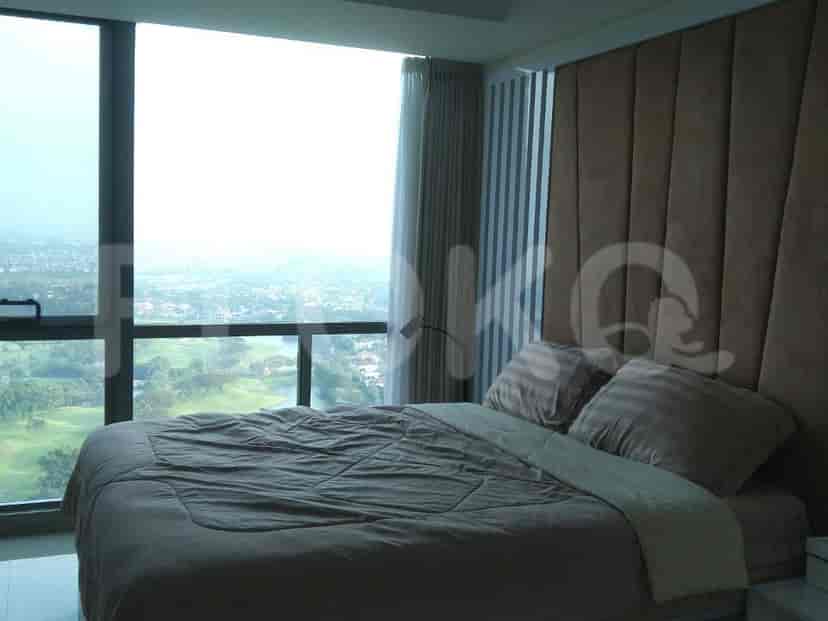 Bedroom with a view and a large headboard.