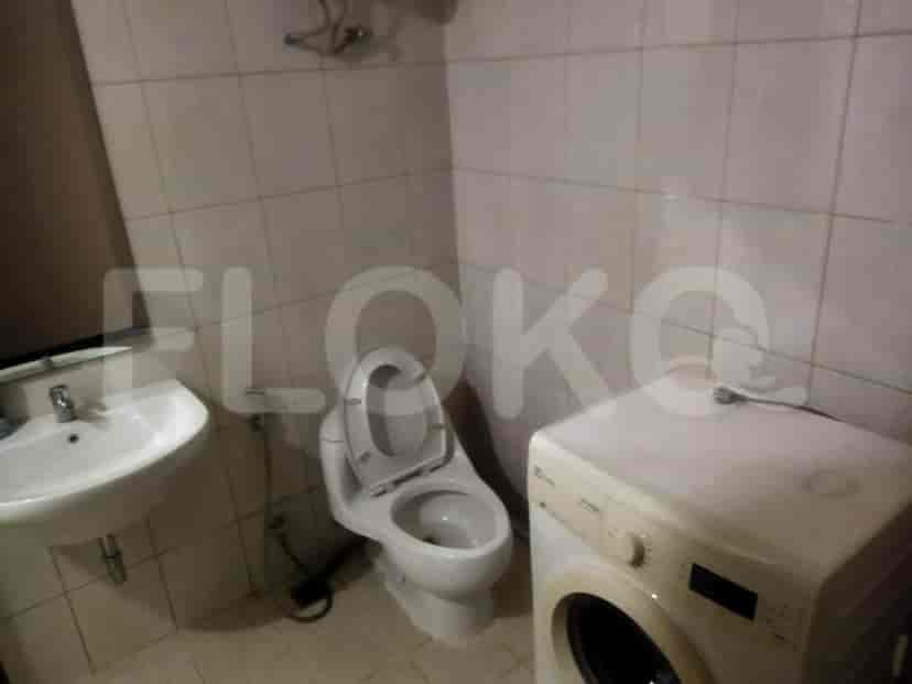 Bathroom with a toilet, sink, and washing machine.