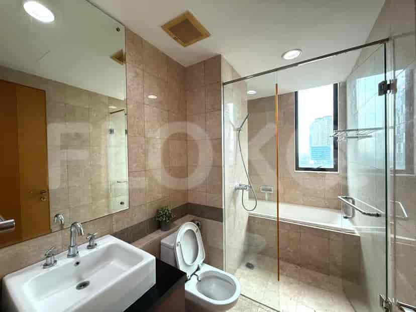 A modern bathroom with a bathtub and a glass shower enclosure.