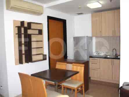 Compact and functional kitchen with wooden cabinets and essential appliances.