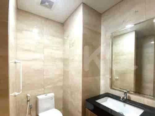 A bathroom with a toilet, sink, and large mirror.