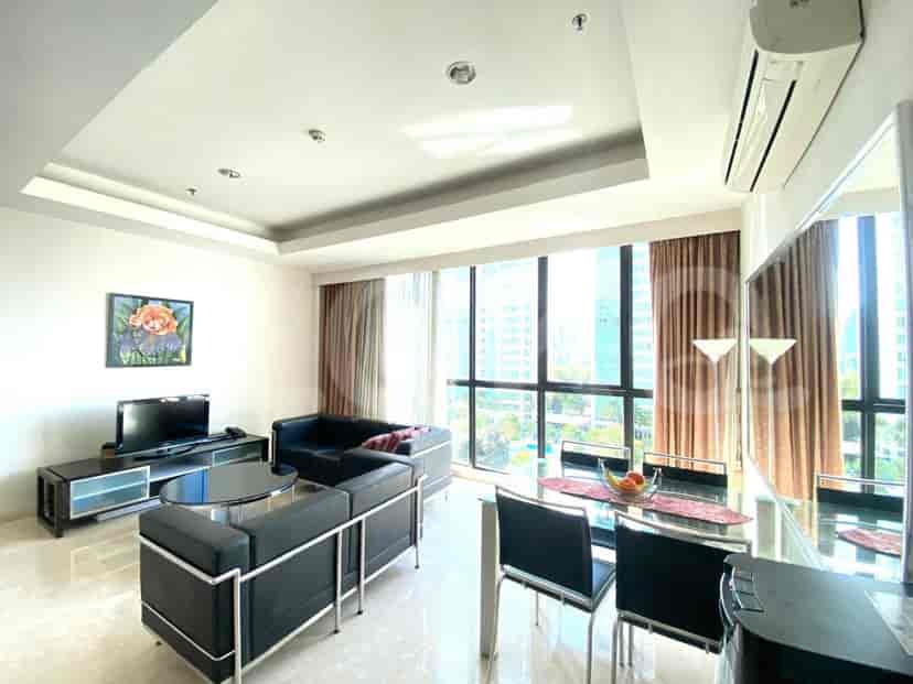 A spacious living and dining area with a view of the city.