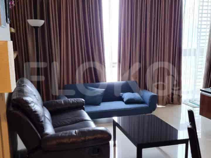Living room with a blue sofa, black coffee table, and brown curtains.