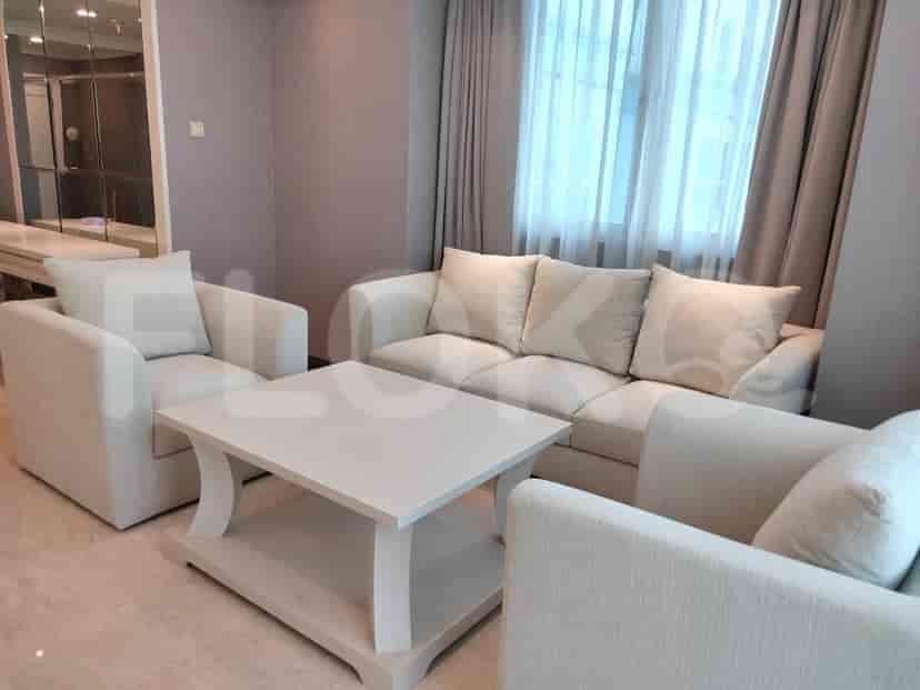 A living room featuring cream-colored furniture and a white coffee table.