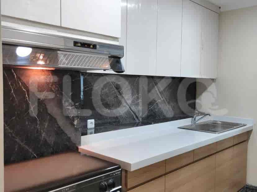 A modern kitchen with cabinets and countertop.