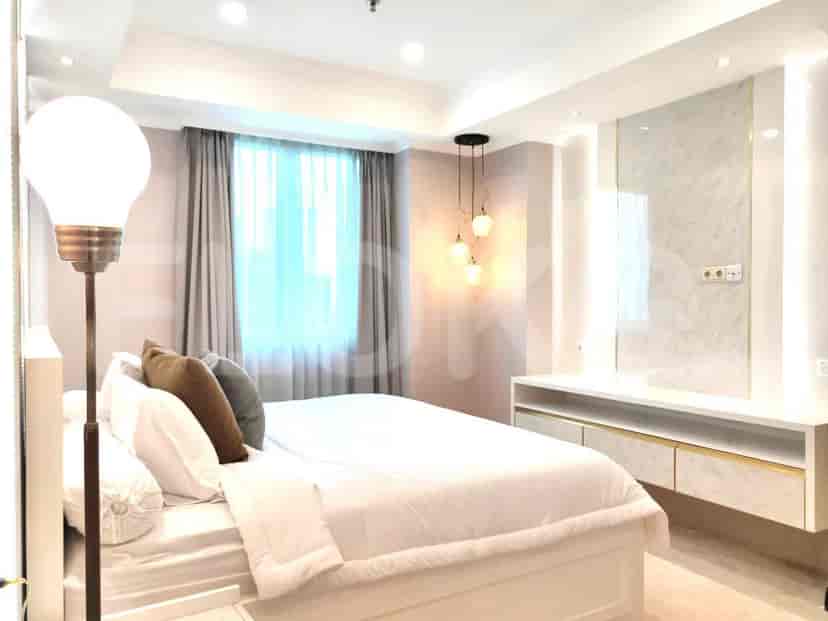 A bedroom featuring a bed, curtains, and a lamp.