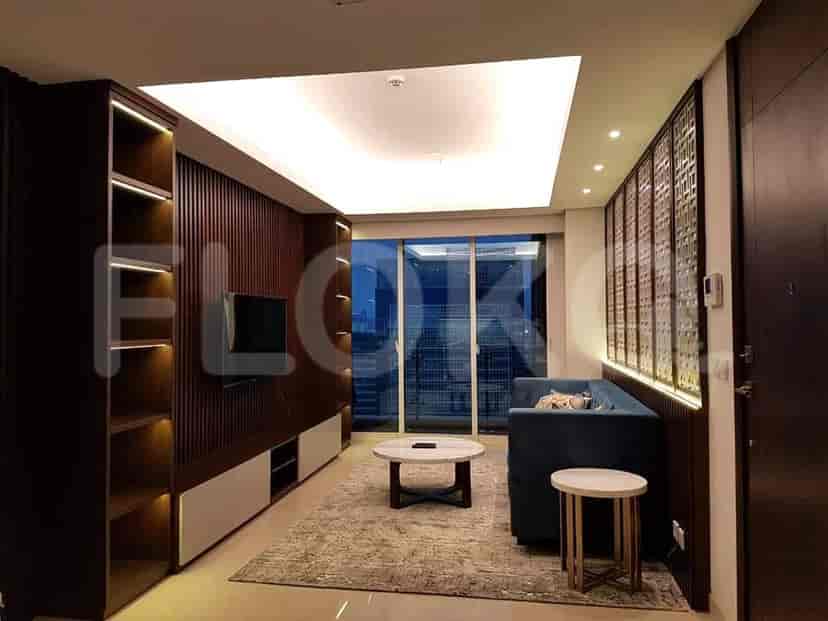 Modern living room featuring a blue sofa, a round coffee table, and built-in entertainment unit.