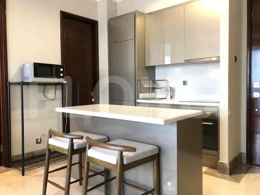 Dapur modern dengan meja sarapan dan peralatan stainless steel.