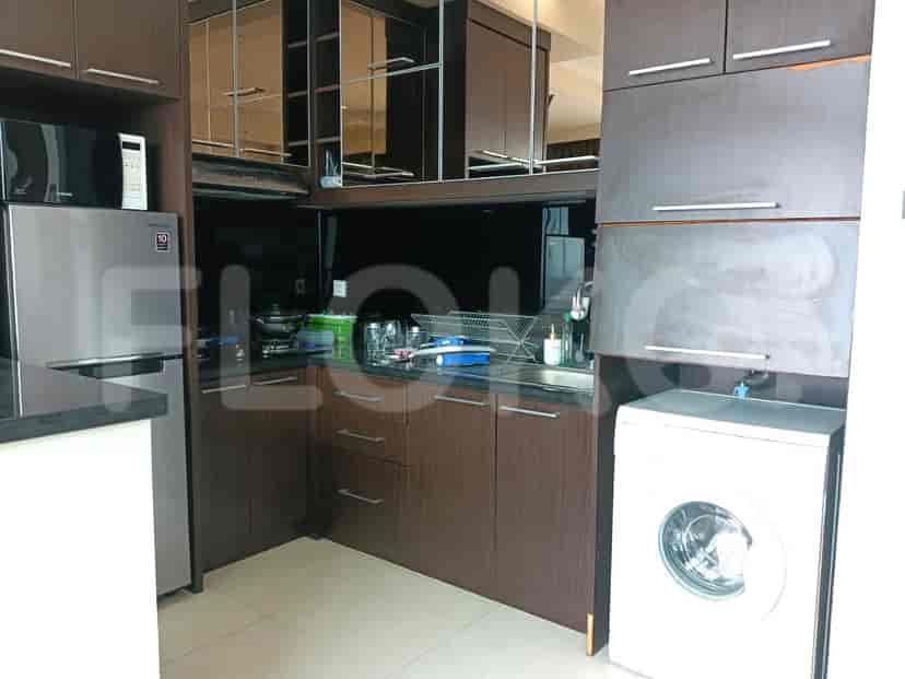 A modern kitchen with stainless steel appliances and dark wood cabinets.