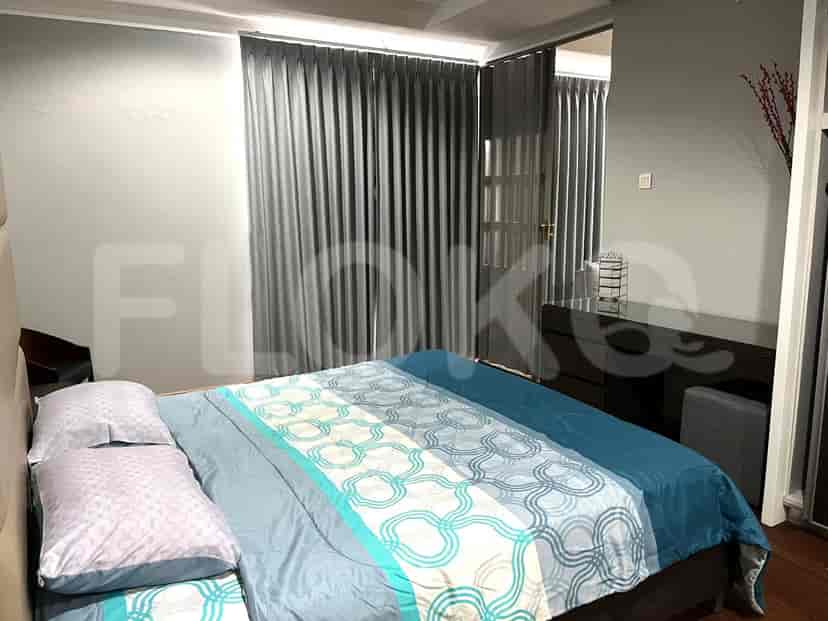 Bedroom with a bed, curtains, and a dresser.