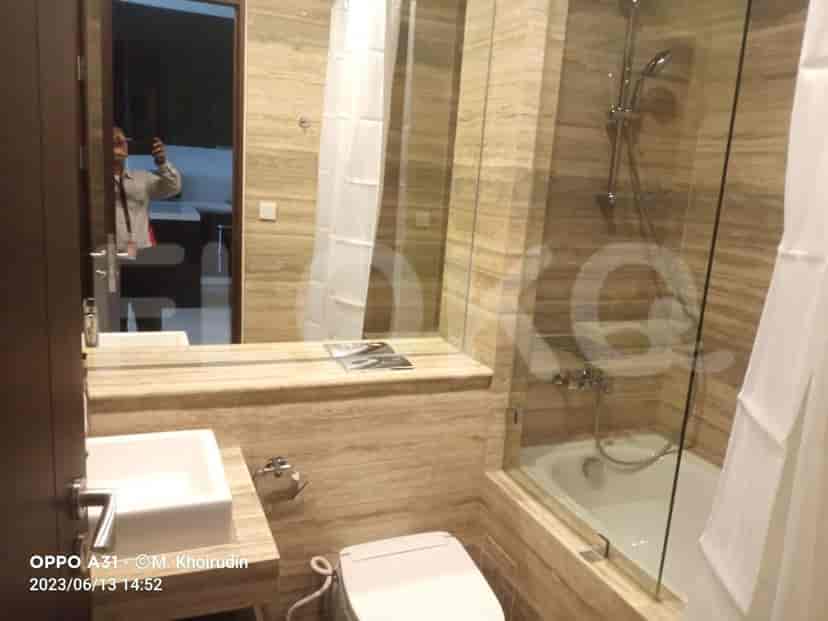 Contemporary bathroom with a glass-enclosed shower, bathtub, and a large mirror.