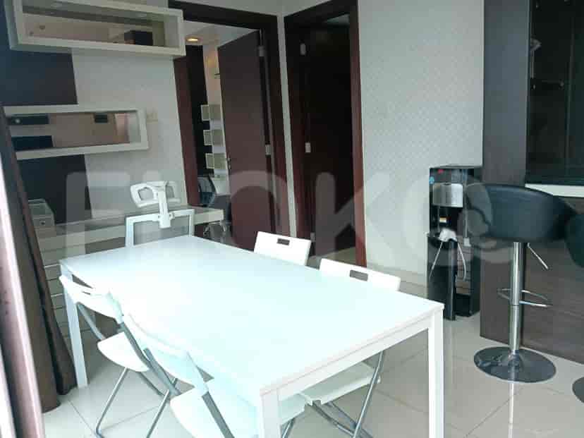 The dining area with a white table, foldable chairs, and a view of the dining and kitchen area.
