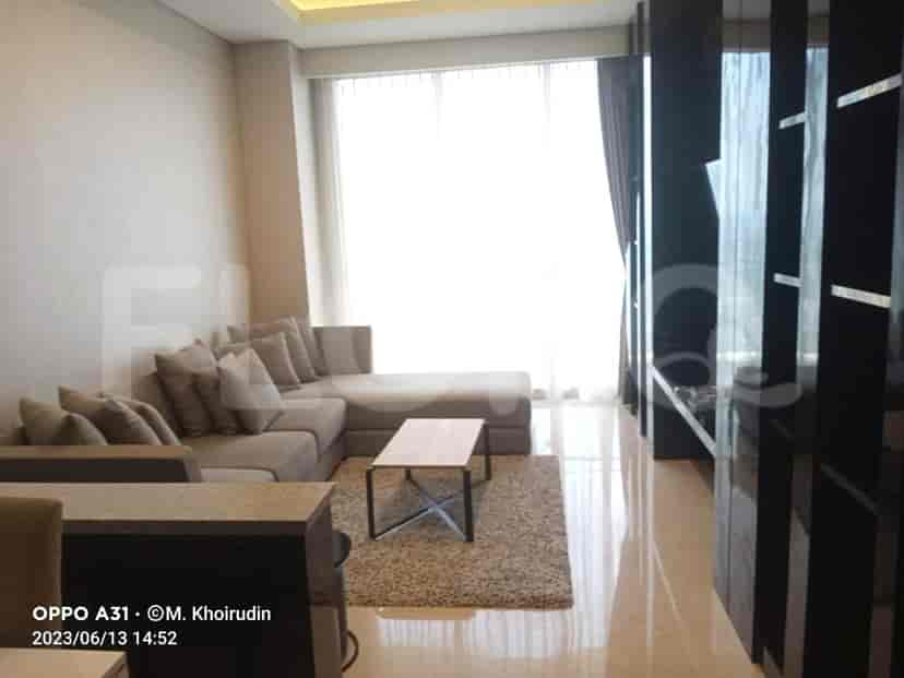 Modern living room with a grey L-shaped sofa, coffee table, and floor-to-ceiling window.