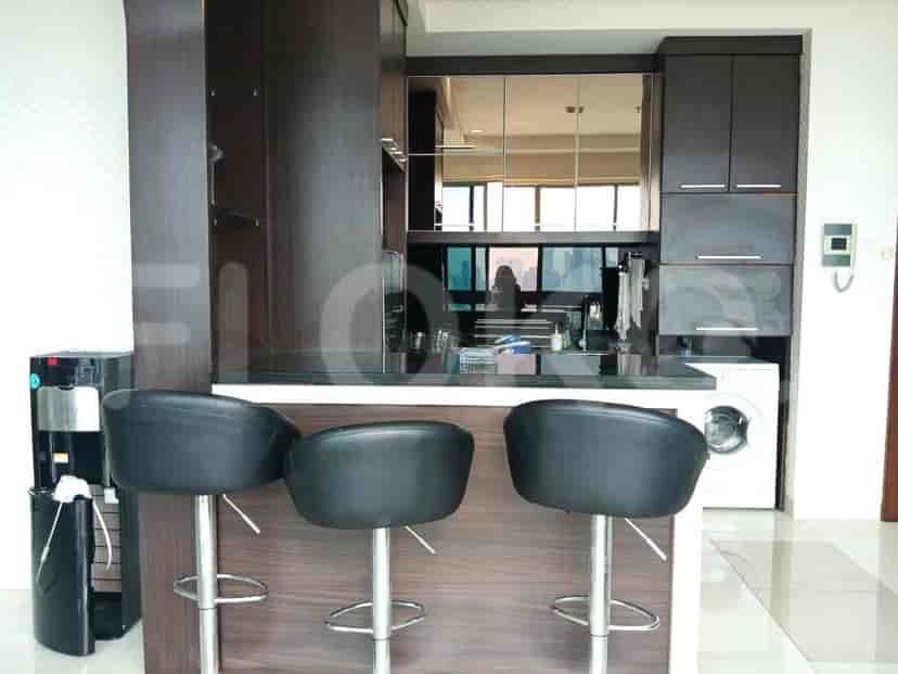 Kitchen area with a bar and seating.