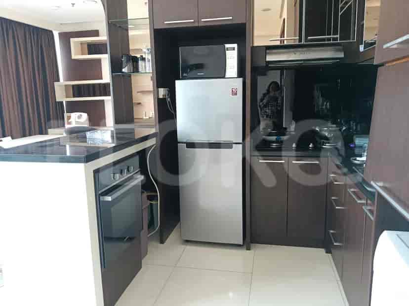 Another view of the kitchen with modern appliances, including a microwave and a refrigerator.