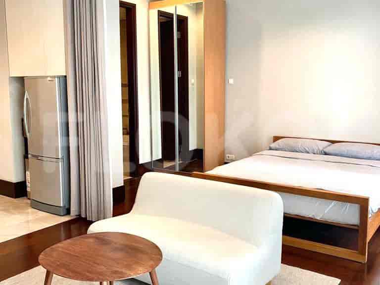 Bedroom with a bed, sofa, and wardrobe.