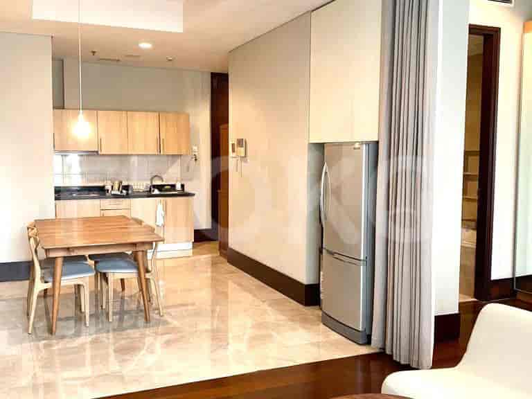 Kitchen with a dining table, refrigerator, and cabinets.