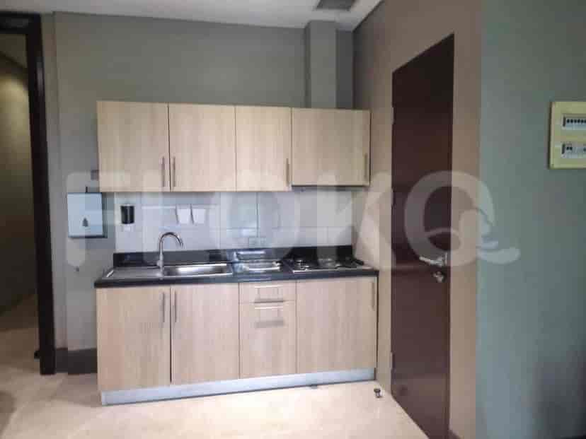Compact kitchen area with wooden cabinets.