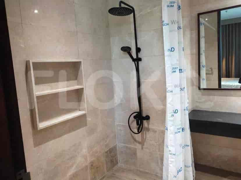 Modern bathroom with rain shower and neutral tones.
