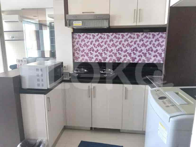 Kitchen with cabinetry, microwave, and gas stove.