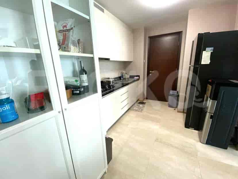 Modern kitchen with white cabinets and a black countertop.