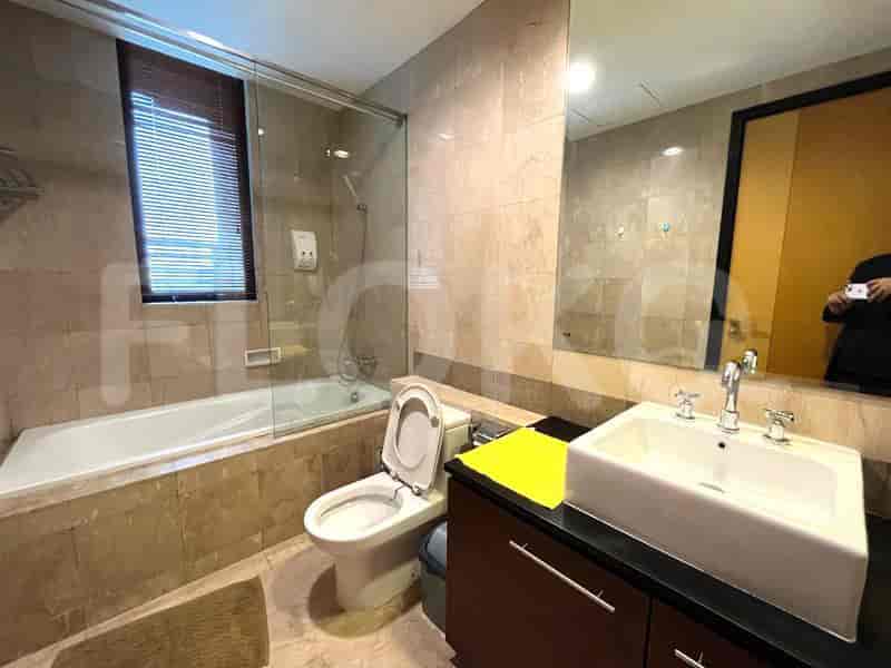 A bathroom with a bathtub, a toilet, and a sink.