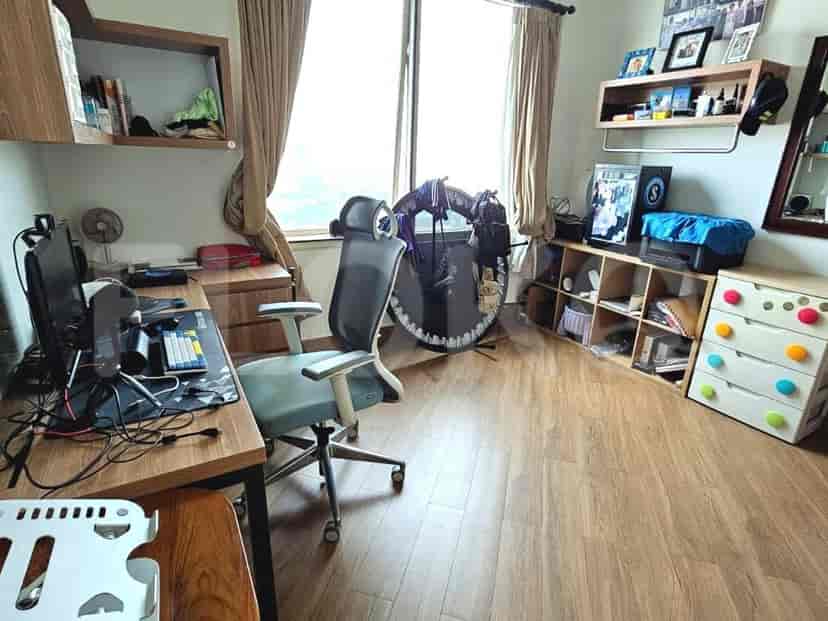Home office setup with a desk, chair, and shelves.