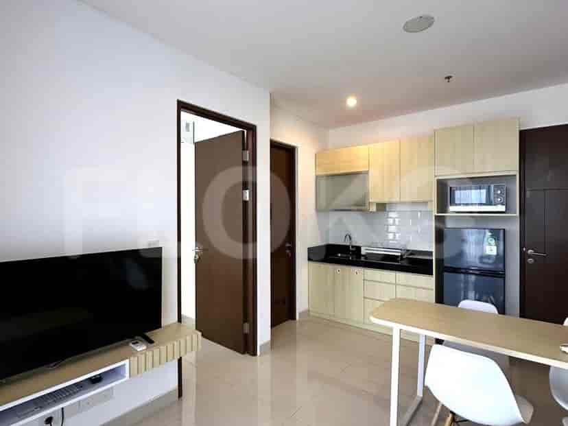 A view of the open concept apartment, with the kitchen and dining and living areas.