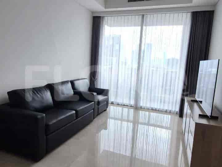A modern living room with a black sofa, TV cabinet, and large windows with curtains.
