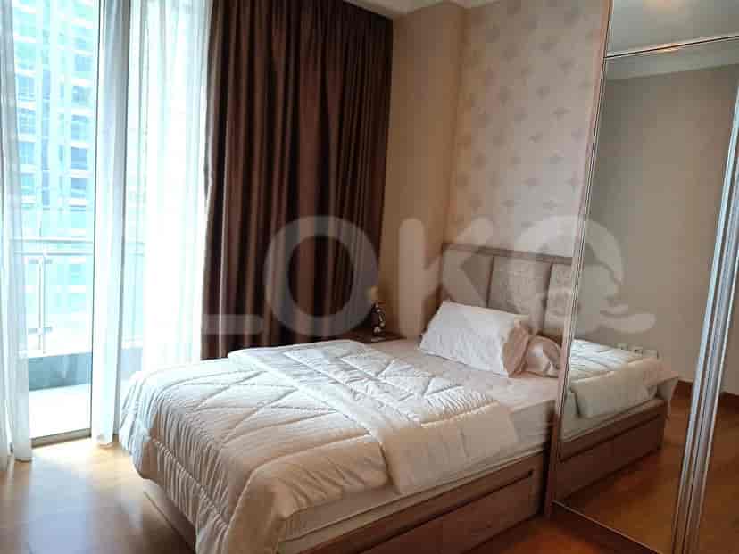 Bedroom with bed, window, and mirror.