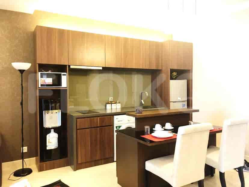 A kitchen with wooden cabinets, a microwave, and a dining table.