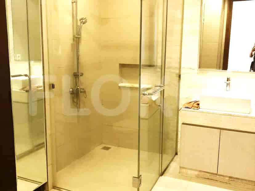 A bathroom with a glass shower enclosure, a modern vanity, and a mirror.