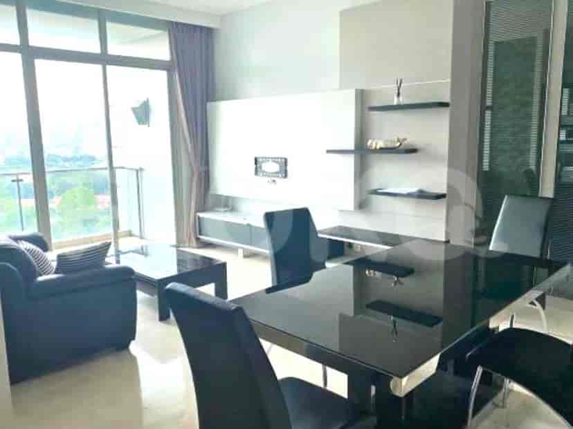Modern living and dining space with a black dining table and a large window.