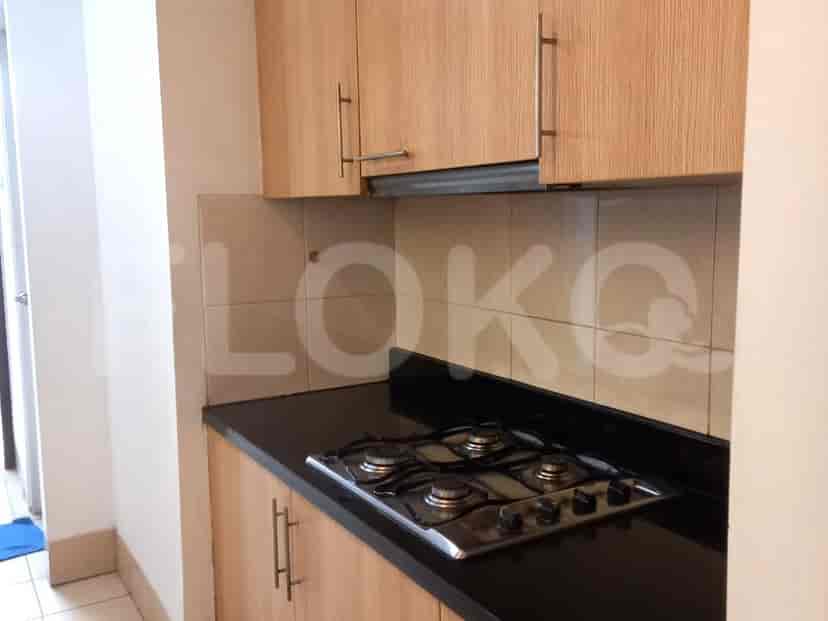 A compact kitchen with a gas stove and cabinets.