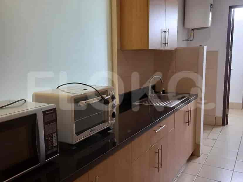 A functional kitchen with a microwave, oven, and sink.