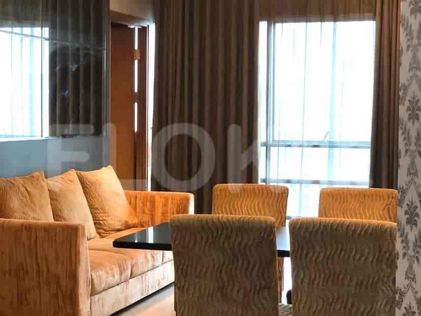 The living and dining area with a view of the windows and curtains.
