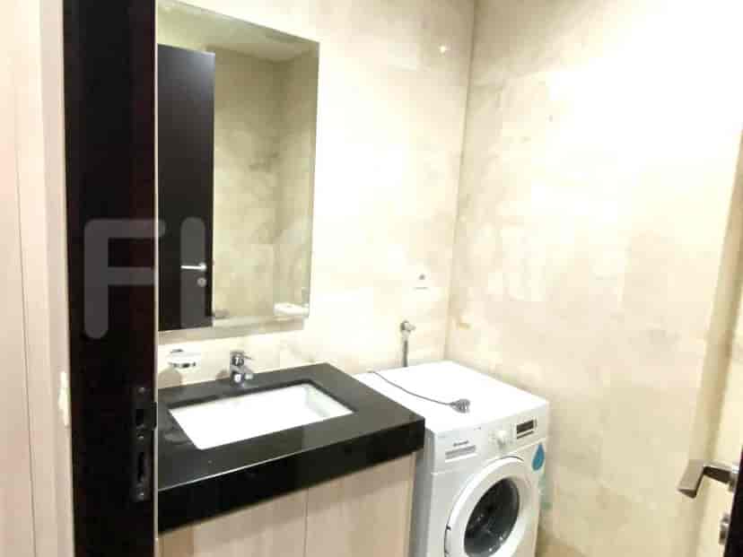 Bathroom with a sink and washing machine.