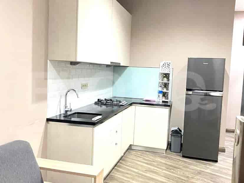 Kitchen with a stove, sink, and refrigerator.