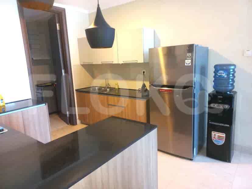 Modern kitchen with stainless steel appliances, a breakfast bar, and dark countertops.