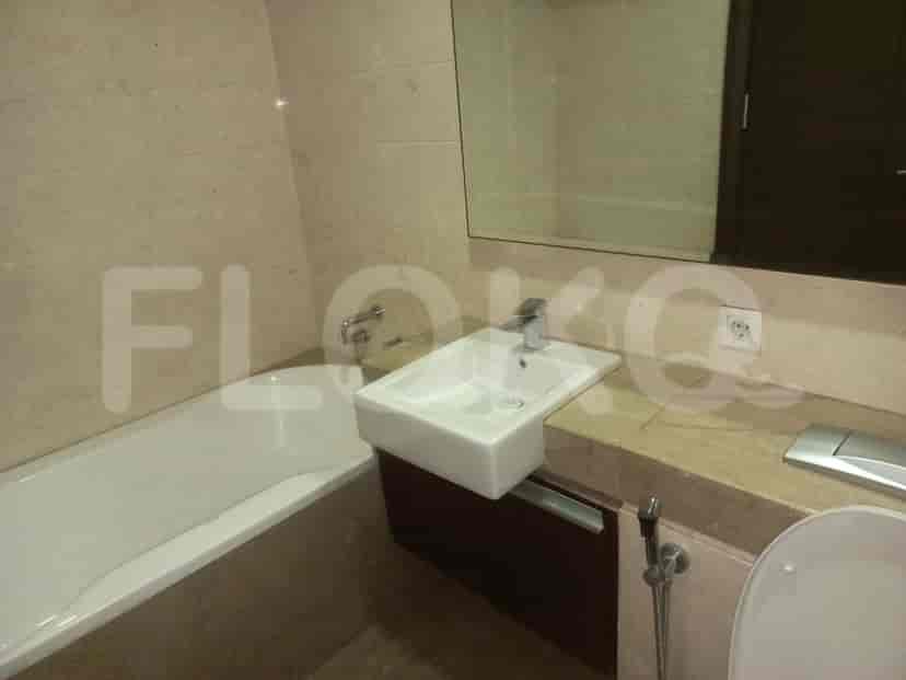 Contemporary bathroom featuring a bathtub, sink, and a large mirror.