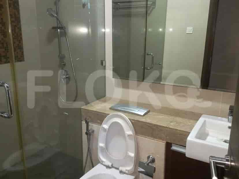 Modern bathroom with a glass shower, toilet, and a sink.