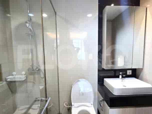 Modern bathroom with a glass-enclosed shower, a sink, and toilet.