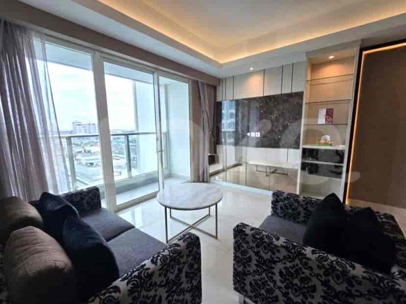 A modern living room with a patterned sofa, a marble-topped coffee table, and a balcony with city views.