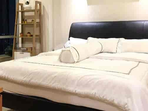 A cozy bedroom with a bed and decorative elements.